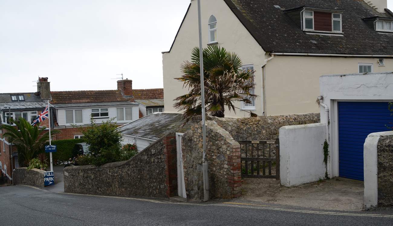 This is the view as you descend Cobb Road. The little gate is the access path to Cobb Cottage and the parking is just below. Turn right into the car park and the allocated space is at the end on the right.