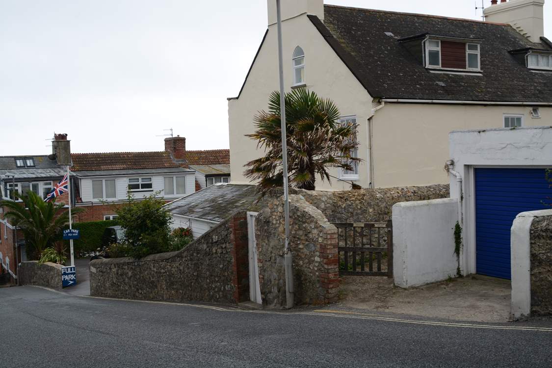 This is the view as you descend Cobb Road. The little gate is the access path to Cobb Cottage and the parking is just below. Turn right into the car park and the allocated space is at the end on the right.