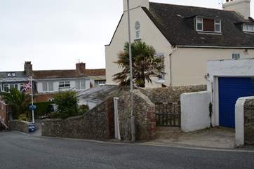 This is the view as you descend Cobb Road. The little gate is the access path to Cobb Cottage and the parking is just below. Turn right into the car park and the allocated space is at the end on the right.