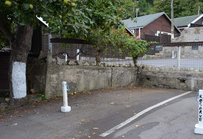 This is the marked parking space for Cobb Cottage, the space beside the tree marked with white paint. The cottage is just above accessed via a footpath.