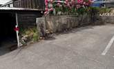 The parking space for Cobb Cottage is located to the back far right of the car park (adjacent to the tree stump). The cottage is just above, accessed via a footpath. - Thumbnail Image