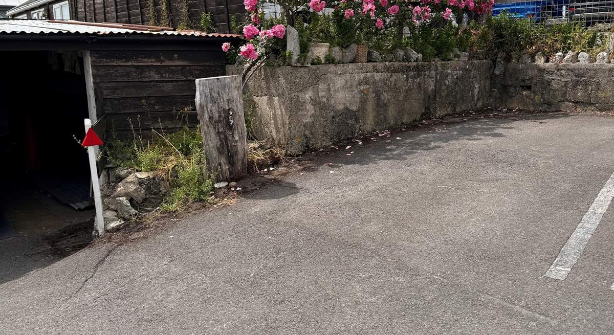 The parking space for Cobb Cottage is located to the back far right of the car park (adjacent to the tree stump). The cottage is just above, accessed via a footpath.