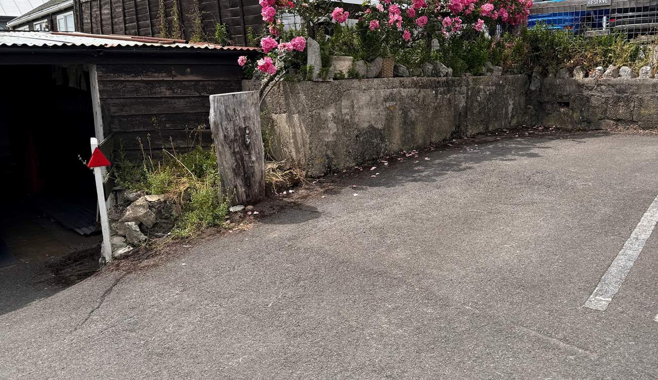The parking space for Cobb Cottage is located to the back far right of the car park (adjacent to the tree stump). The cottage is just above, accessed via a footpath.