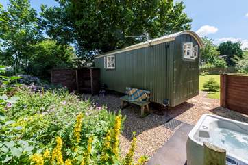The hot tub is positioned in a private spot to the side of the hut but fully screen fenced for privacy.