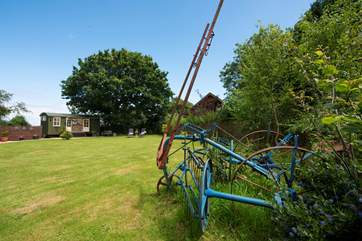 There is a reminder you are on a working farm with clever use of old farm machinery as garden ornaments.