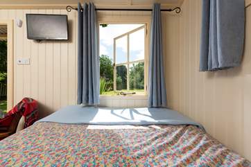 There is a picture window at the bottom of your bed and there is even a TV too!