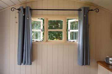 A pretty window above the bed as well as a picture window at the end of the bed.