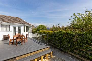 French doors from the sitting room lead out to the rear deck which catches the morning sun.