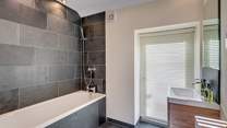 Light pours in to this gorgeous en suite bathroom (Bedroom 1).
