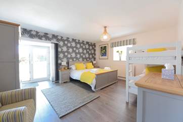 The family bedroom gives access to the hot tub and the terrace.