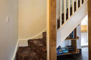 Gorgeous bare oak beams support the cottage-style stairs to the bedrooms.