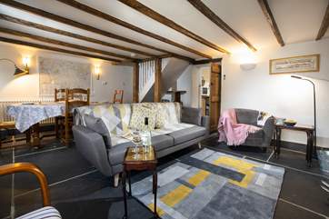 The wonderful sitting area offers a place to sit back and enjoy a room that also benfits from a log burner.