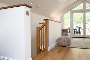 The stairs lead down from the living area to the bedrooms and bathroom.