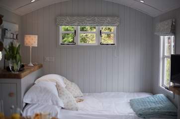 The bed has its own picture window overlooking the patio and buttercup meadow beyond.