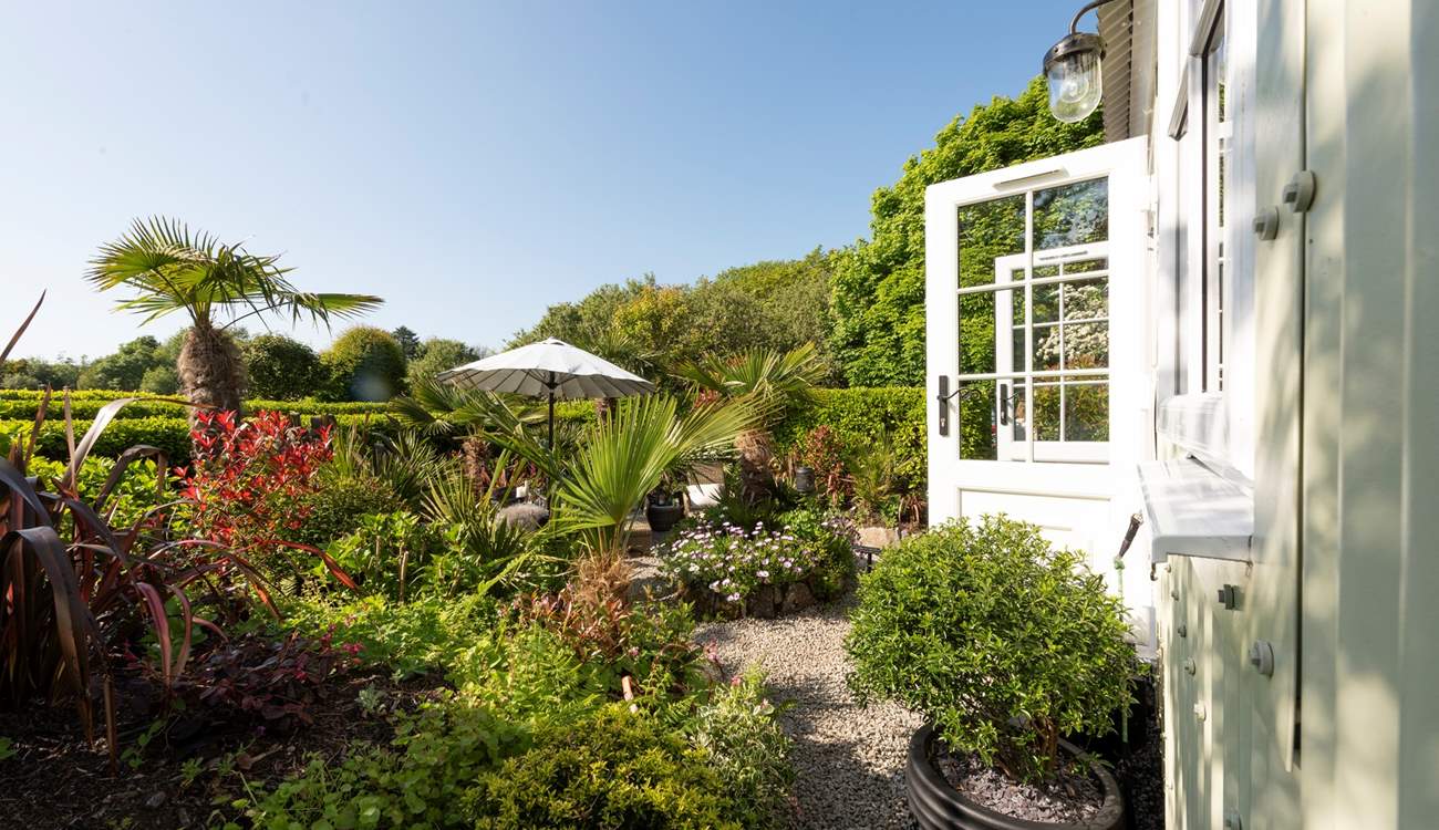 The outside space of dreams, surrounded by beautiful flowers, plants and trees. 