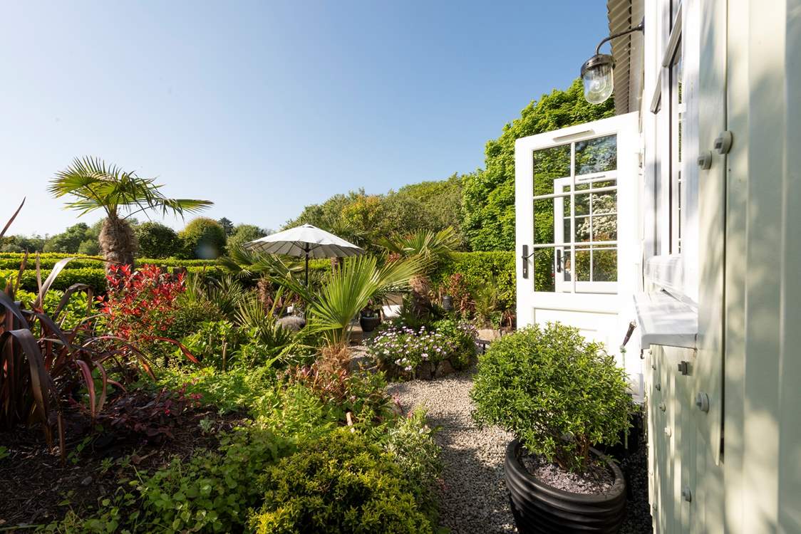 The outside space of dreams, surrounded by beautiful flowers, plants and trees.