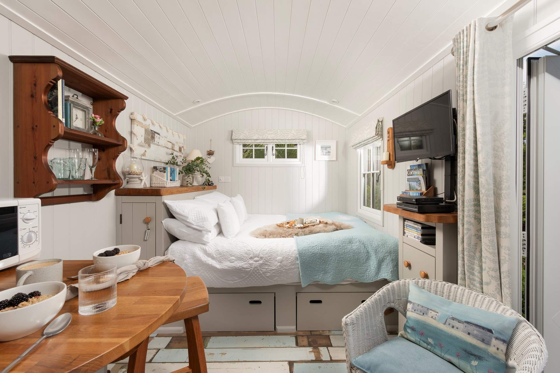 Sink into the comfy king-size bed and enjoy views of the patio and buttercup meadow beyond.