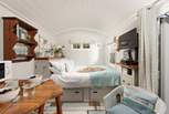 Sink into the comfy king-size bed and enjoy views of the patio and buttercup meadow beyond.