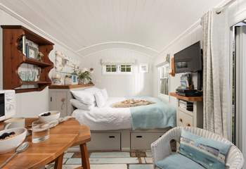 Sink into the comfy king-size bed and enjoy views of the patio and buttercup meadow beyond.