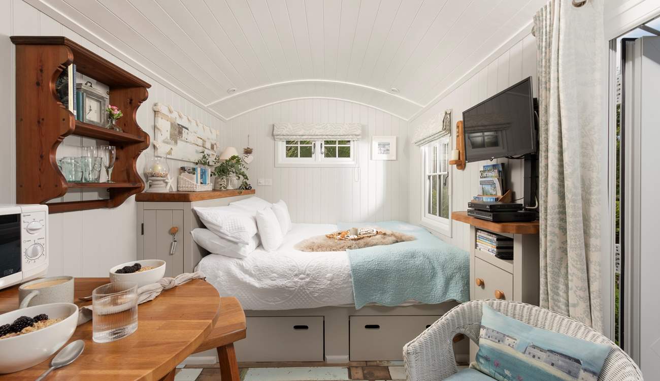 Sink into the comfy king-size bed and enjoy views of the patio and buttercup meadow beyond.