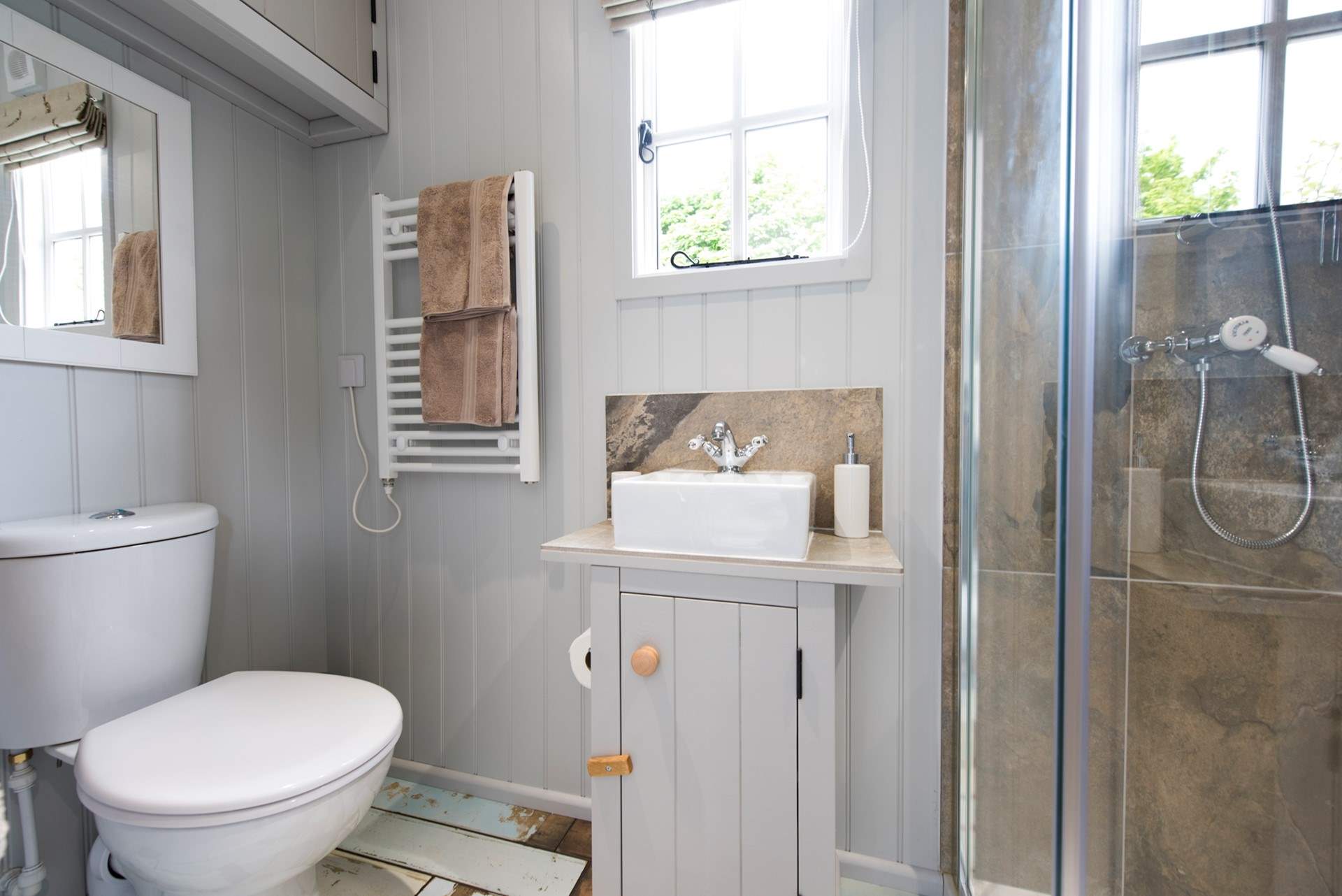 The beautiful bathroom sits at the end of the hut.