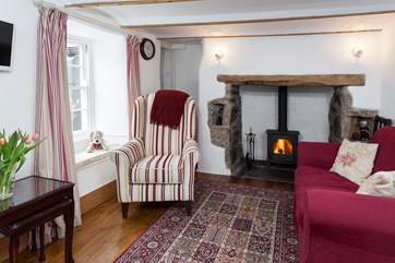 The sitting-room is the perfect place to relax with the comfy sofas and roaring wood-burner.
