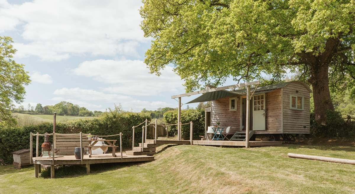 Nestled beneath an ancient oak tree, the setting is simply enchanting. 