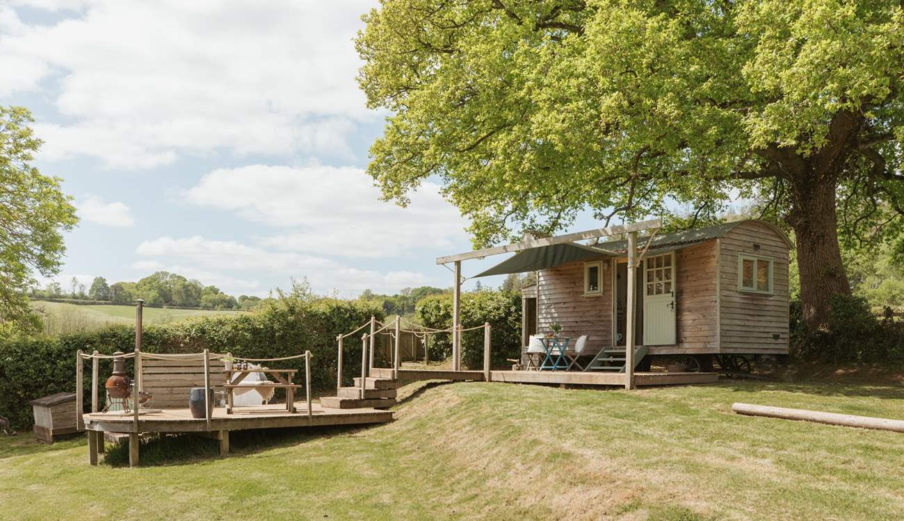 Nestled beneath an ancient oak tree, the setting is simply enchanting. 
