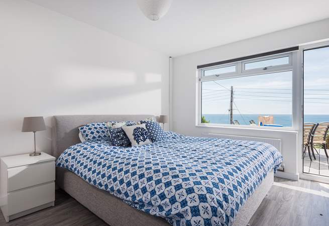 The fabulous master bedroom is located on the lower ground floor and has a door out onto the garden decking.