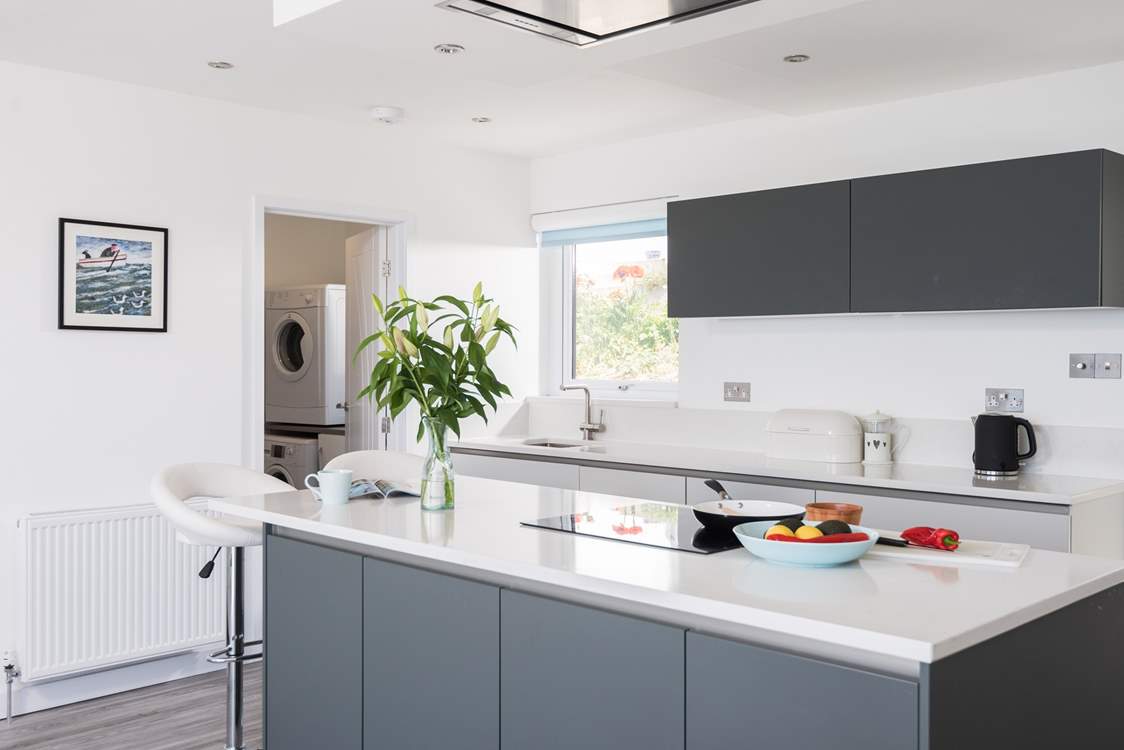 The useful utility-room is located just off the kitchen and has a washing machine and tumble-drier.