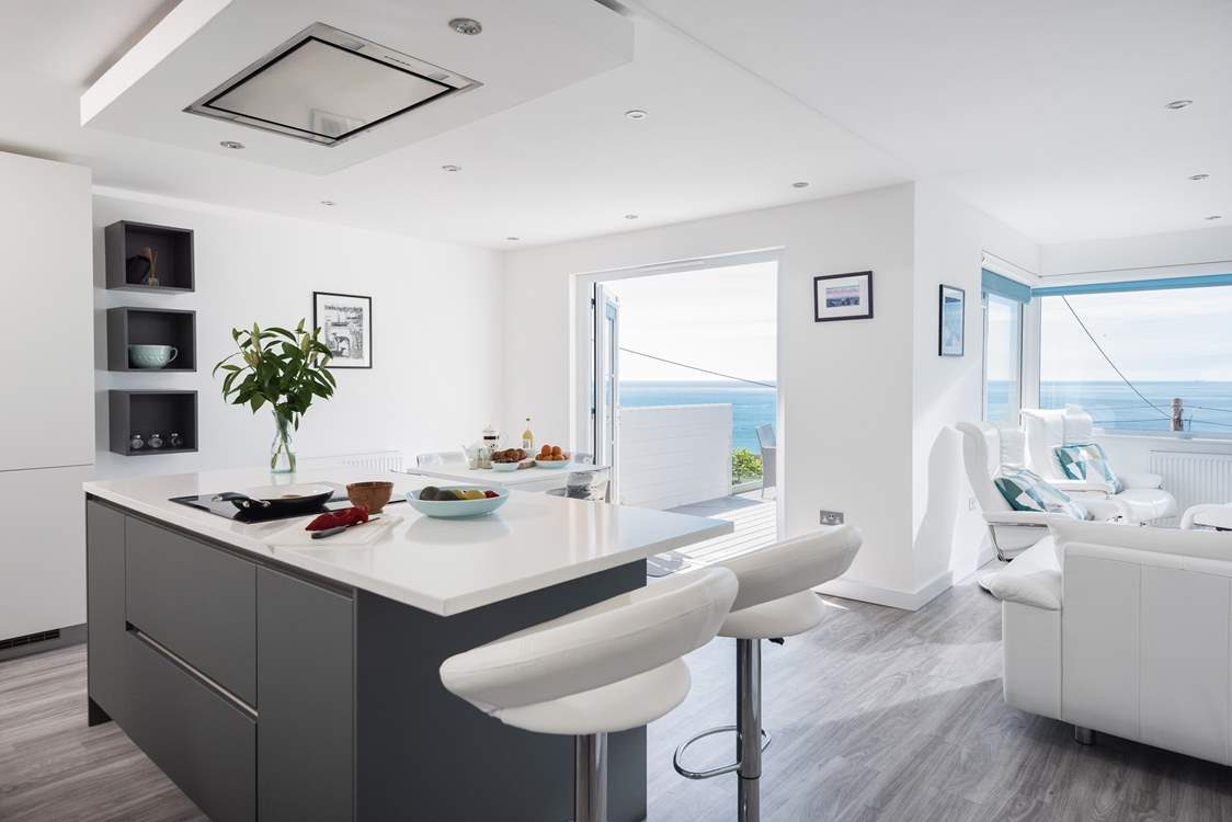 The open plan living-room with areas to cook, eat and relax.