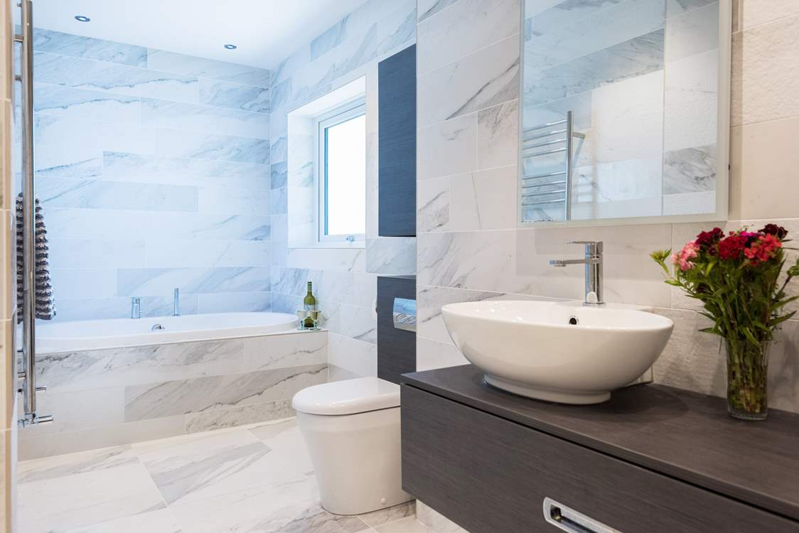 The bathroom is large and very glamorous with a choice of coloured lights over the bath.
