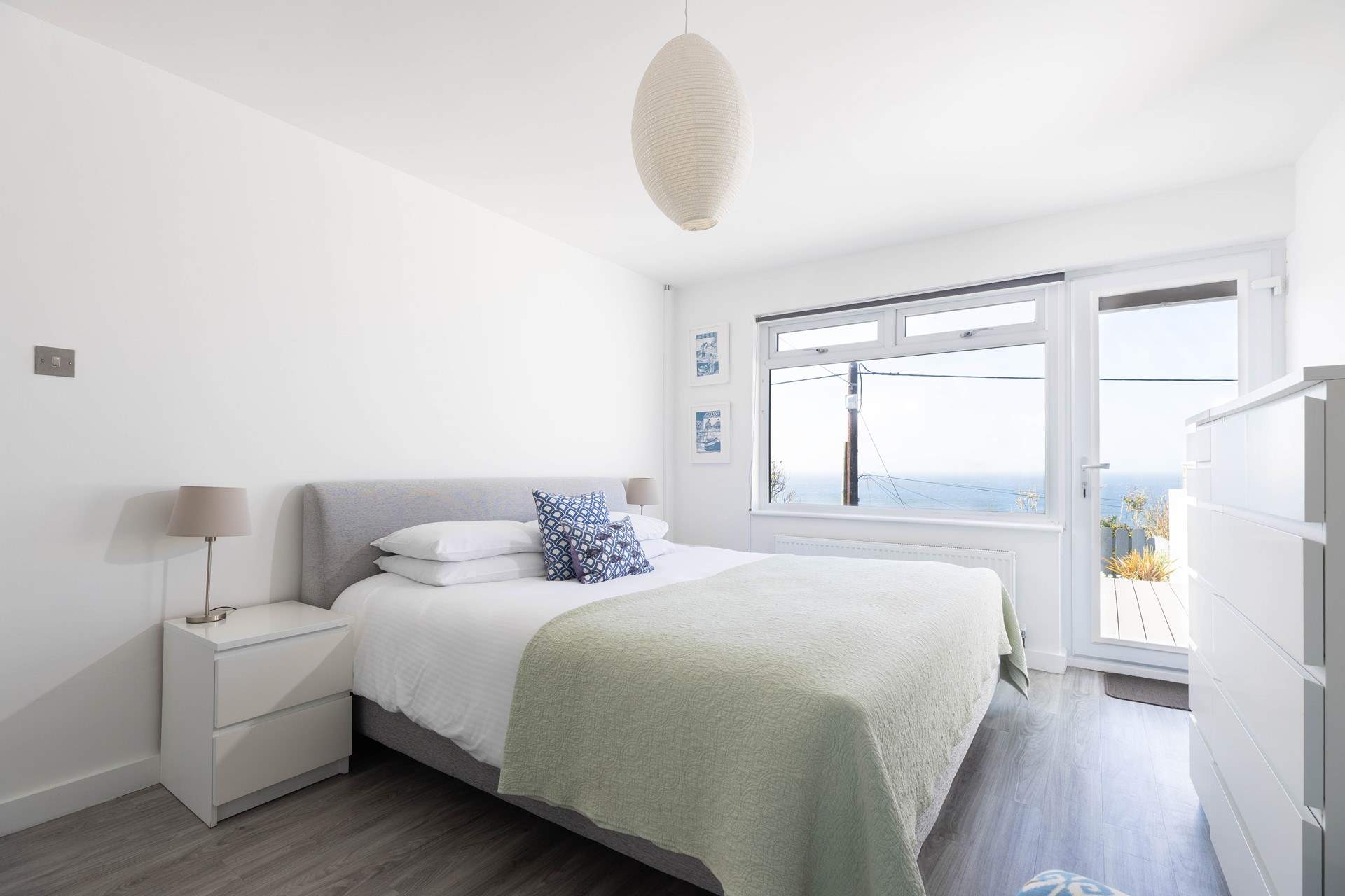 The fabulous main bedroom is located on the lower ground floor and has a door out onto the garden decking.