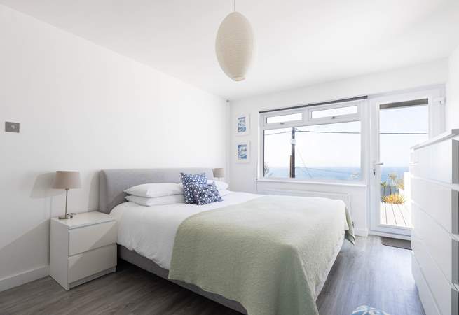 The fabulous main bedroom is located on the lower ground floor and has a door out onto the garden decking.
