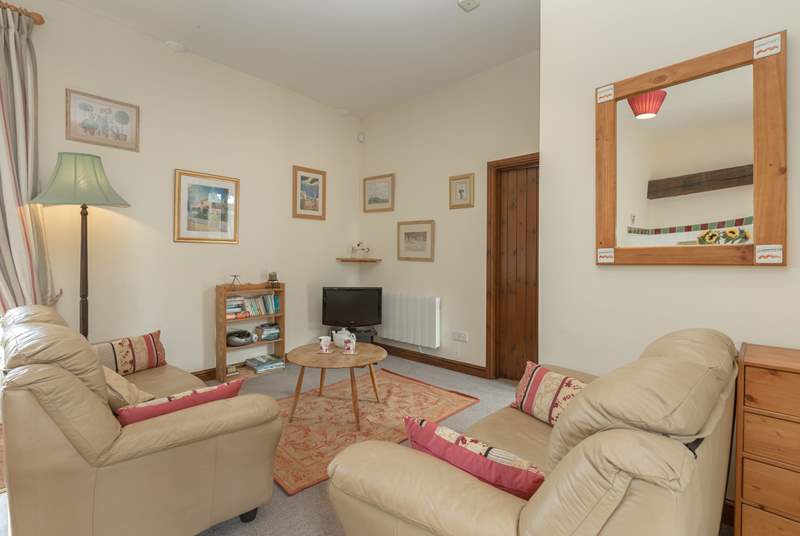 This is the cosy living room part of the open plan ground floor.  The door in the photograph is to the main bedroom