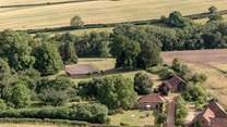 To give a sense of scale, the grounds spread out behind and to the right of Orchard Barn with a view of the tennis court in the distance...