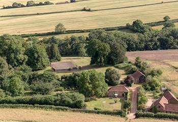 To give a sense of scale, the grounds spread out behind and to the right of Orchard Barn with a view of the tennis court in the distance...
