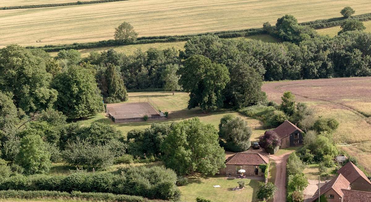 To give a sense of scale, the grounds spread out behind and to the right of Orchard Barn with a view of the tennis court in the distance...