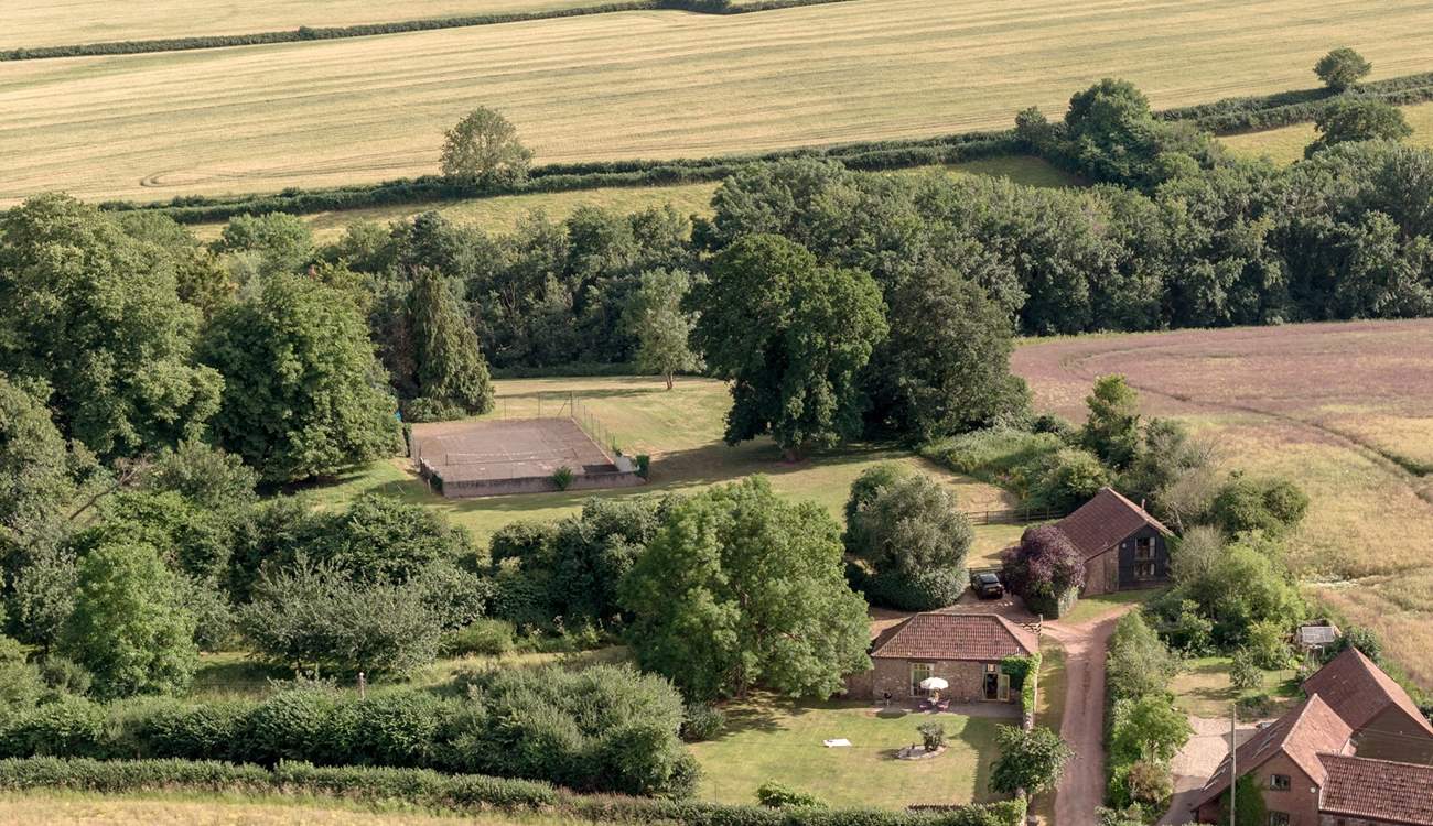 To give a sense of scale, the grounds spread out behind and to the right of Orchard Barn with a view of the tennis court in the distance...