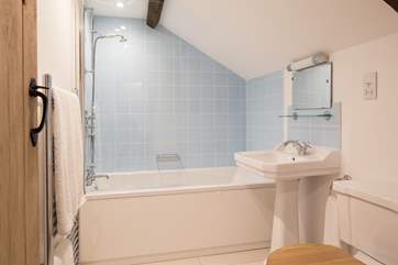 The sparkling blue and white family bathroom.