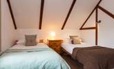 The twin bedroom also has cosy sloped ceilings. - Thumbnail Image