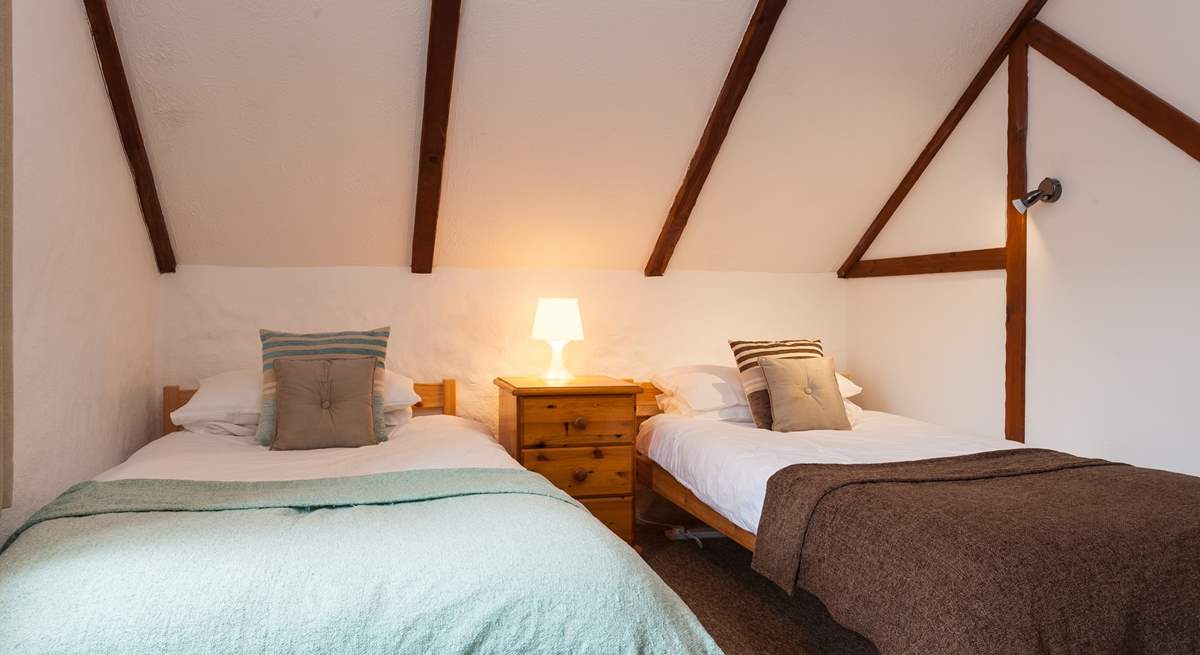 The twin bedroom also has cosy sloped ceilings.