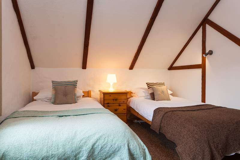 The twin bedroom also has cosy sloped ceilings.