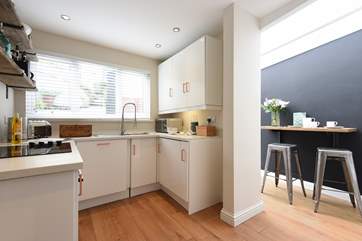 The kitchen/diner is compact but ideal for preparing light meals, and there's a small breakfast-bar.