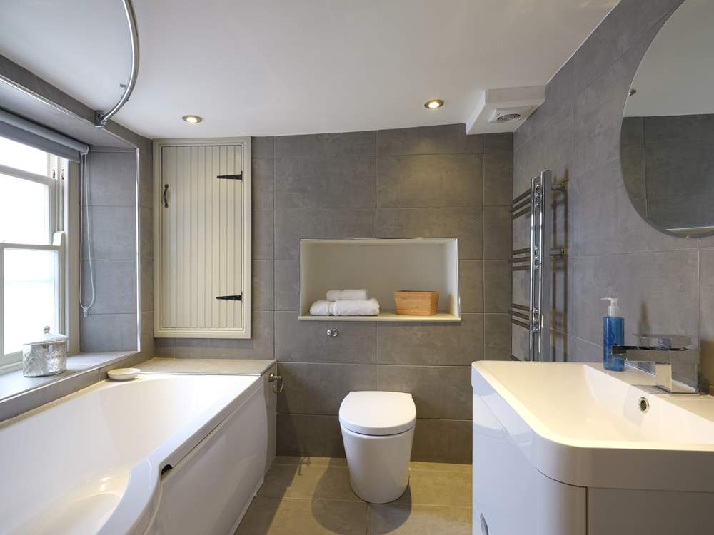 Contemporary bathroom fittings contrast beautifully with the old cottage