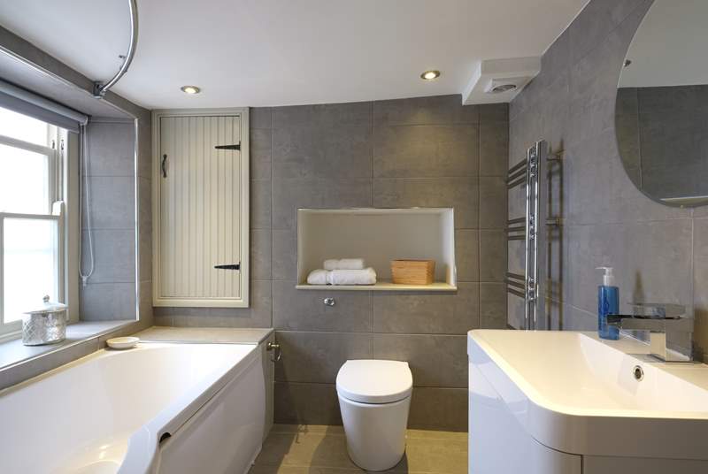 Contemporary bathroom fittings contrast beautifully with the old cottage