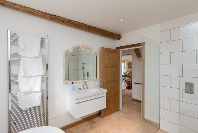 The huge bathroom has a walk-in shower cubicle in addition to the bath.