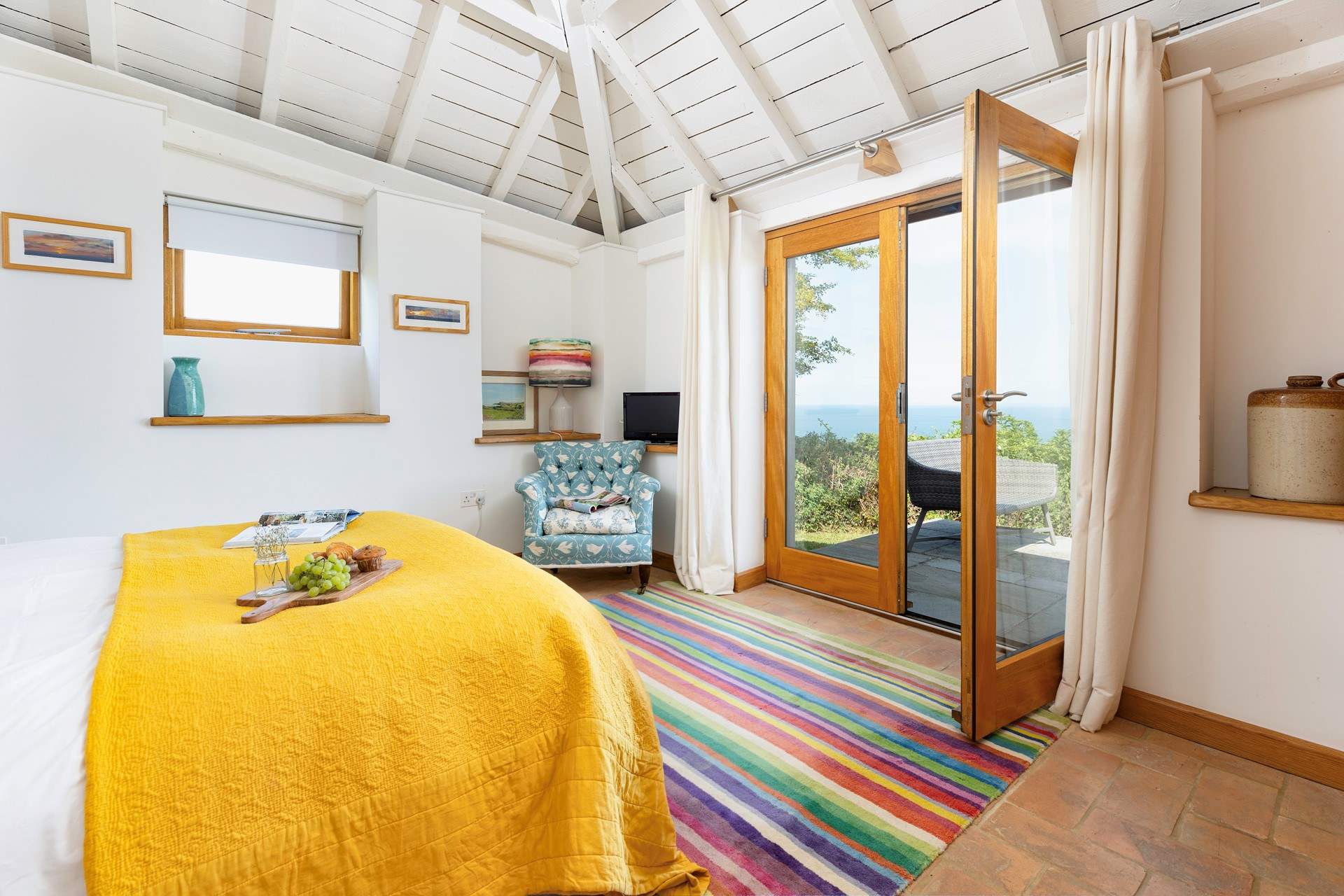 French doors in Bedroom 1 open onto the terrace, you can lie in bed with a cup of tea and breathe in the sea air.