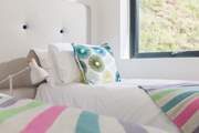 Crisp white linens on quality mattresses with just the right amount of colour.