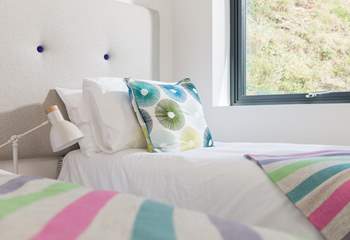 Crisp white linens on quality mattresses with just the right amount of colour.